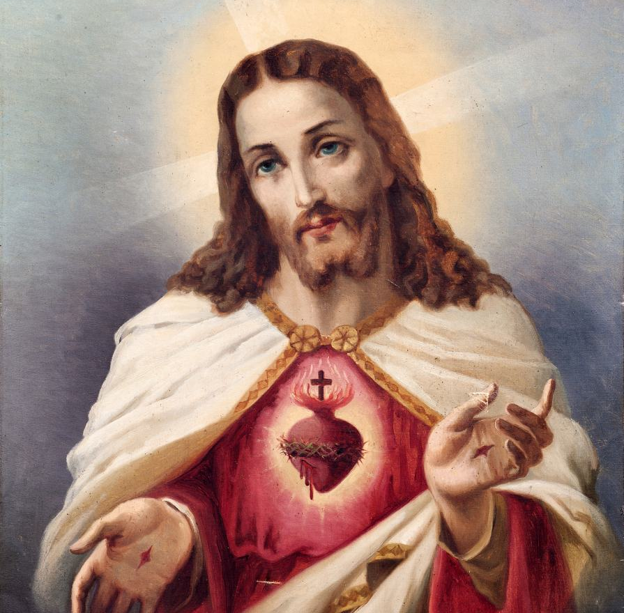 Jesus Christ with Sacred Heart: halo, red robe and white cloak, heart visible on chest with a crown of thorns and cross above it with glow behind head.